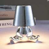 Designer LED tafellamp zittende man met glanzende afwerking