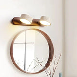 Moderne LED wandlamp met draaibare kappen van steen en een houten basis