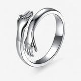 Angelica – Open verstelbare ring met verstrengelde handen