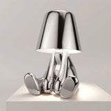 Designer LED tafellamp zittende man met glanzende afwerking
